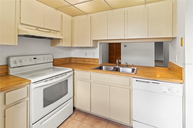 5785 Gardens Dr, Sarasota, FL 34243 - kitchen featuring white appliances, custom exhaust hood, cream cabinetry, and a paneled ceiling