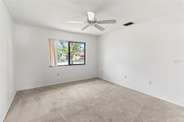 5785 Gardens Dr, Sarasota, FL 34243 - carpeted spare room with a ceiling fan and a textured ceiling