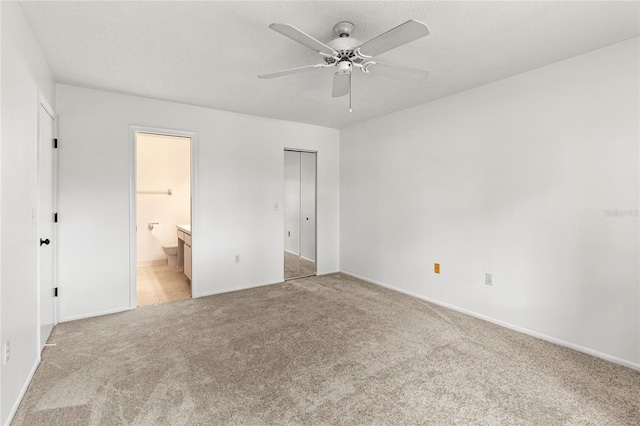 5785 Gardens Dr, Sarasota, FL 34243 - unfurnished bedroom featuring light carpet, ensuite bath, and ceiling fan
