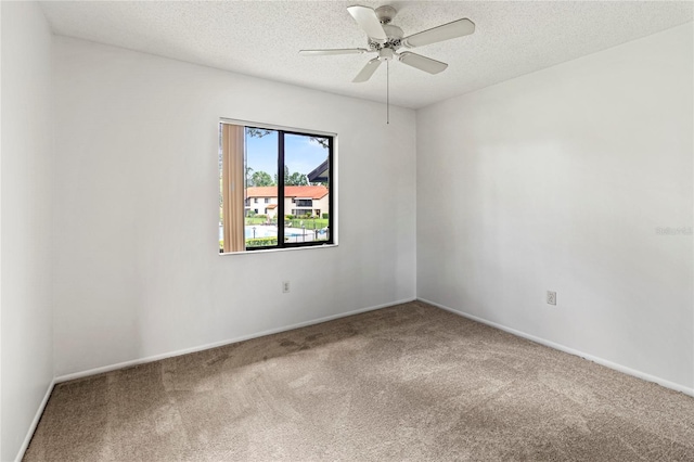 5785 Gardens Dr, Sarasota, FL 34243 - unfurnished room with carpet flooring, a textured ceiling, and ceiling fan