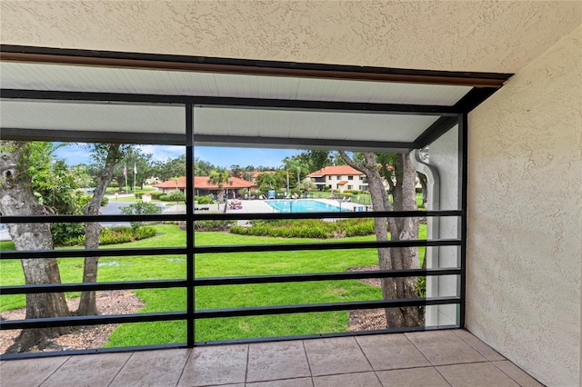 5785 Gardens Dr, Sarasota, FL 34243 - unfurnished sunroom featuring beam ceiling