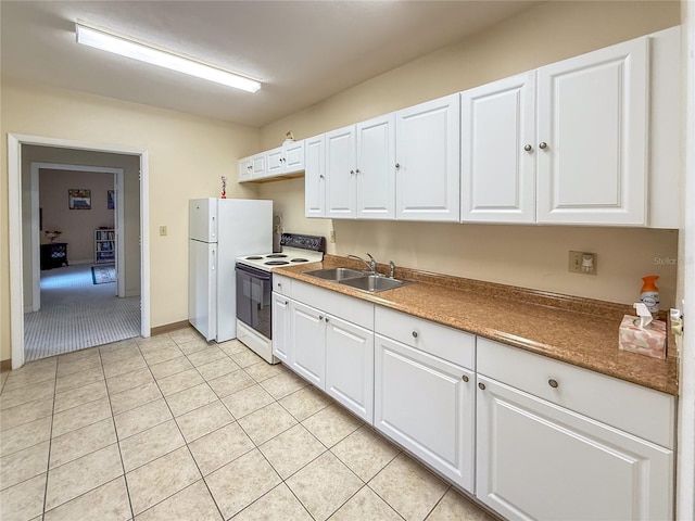 5785 Gardens Dr, Sarasota, FL 34243 - kitchen featuring white appliances, white cabinetry, and light tile patterned floors