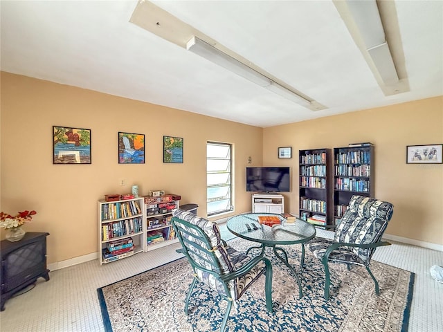 5785 Gardens Dr, Sarasota, FL 34243 - dining room with carpet flooring, attic access, and a wood stove