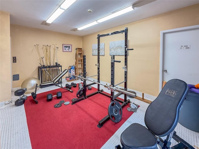 5785 Gardens Dr, Sarasota, FL 34243 - workout room with baseboards and carpet flooring