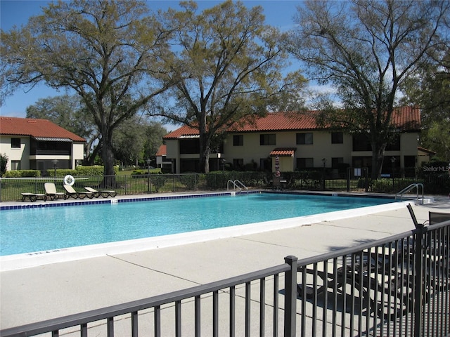 5785 Gardens Dr, Sarasota, FL 34243 - community pool with a patio area