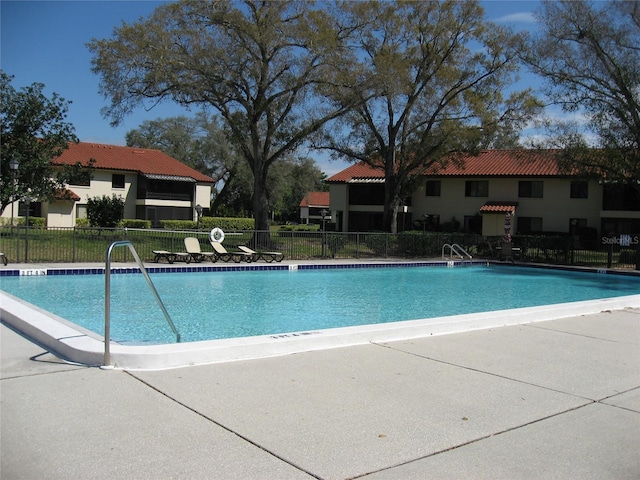 5785 Gardens Dr, Sarasota, FL 34243 - community pool with a patio area
