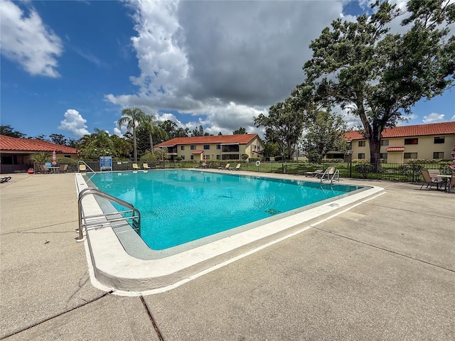 5785 Gardens Dr, Sarasota, FL 34243 - community pool with a patio area