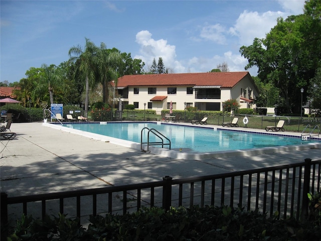 5785 Gardens Dr, Sarasota, FL 34243 - community pool with a patio area