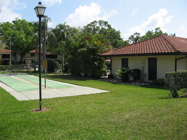 5785 Gardens Dr, Sarasota, FL 34243 - view of grassy yard with shuffleboard