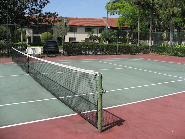 5785 Gardens Dr, Sarasota, FL 34243 - view of tennis court featuring community basketball court