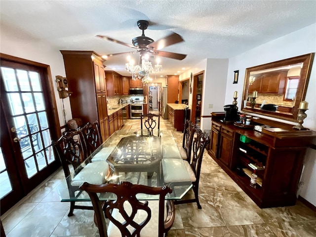 8834 Whispering Oaks Trl, New Port Richey, FL 34654 - dining area featuring a ceiling fan, a textured ceiling, and light marble finish floors