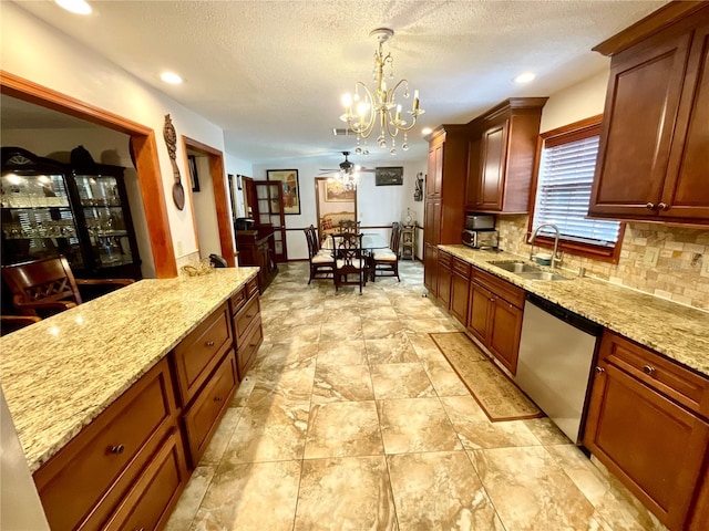 8834 Whispering Oaks Trl, New Port Richey, FL 34654 - kitchen with stainless steel dishwasher, a chandelier, backsplash, light stone countertops, and decorative light fixtures
