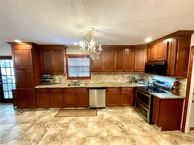 8834 Whispering Oaks Trl, New Port Richey, FL 34654 - kitchen featuring appliances with stainless steel finishes, a chandelier, healthy amount of natural light, tasteful backsplash, and a textured ceiling