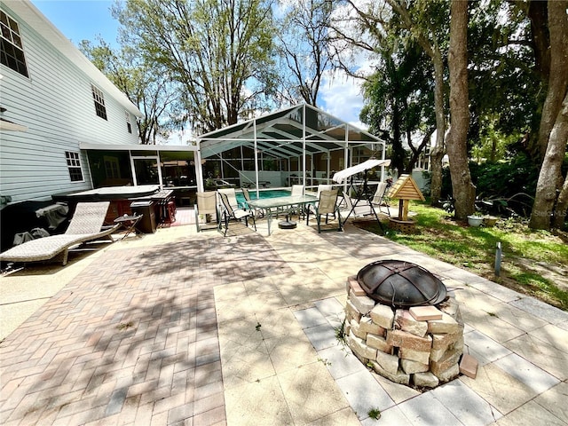 8834 Whispering Oaks Trl, New Port Richey, FL 34654 - view of patio with a hot tub, a fire pit, a swimming pool, and a lanai