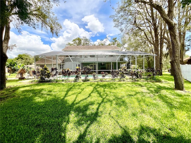8834 Whispering Oaks Trl, New Port Richey, FL 34654 - back of house featuring glass enclosure and an outdoor pool