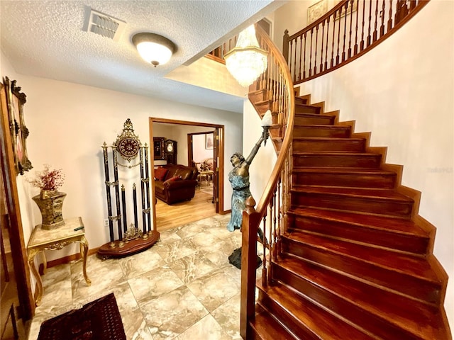 8834 Whispering Oaks Trl, New Port Richey, FL 34654 - stairway with a textured ceiling and baseboards
