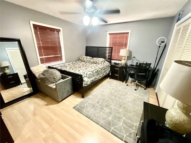 8834 Whispering Oaks Trl, New Port Richey, FL 34654 - bedroom featuring wood finished floors, a closet, a desk, and ceiling fan