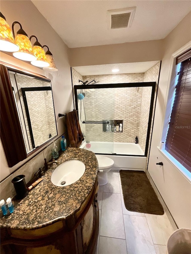 8834 Whispering Oaks Trl, New Port Richey, FL 34654 - bathroom with vanity, bath / shower combo with glass door, and tile patterned floors