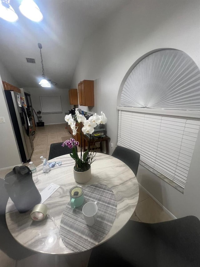 1421 Mohrlake Dr, Brandon, FL 33511 - dining space with vaulted ceiling and light tile patterned flooring