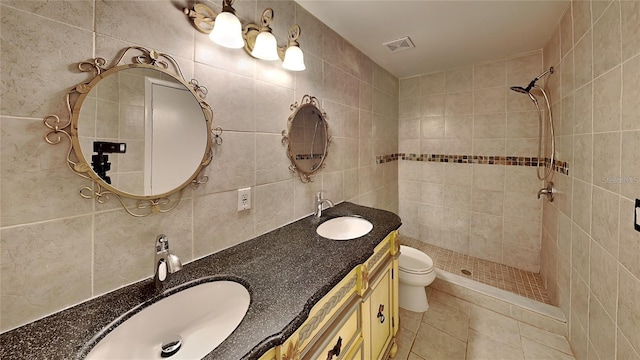 1421 Mohrlake Dr, Brandon, FL 33511 - bathroom with double vanity, a tile shower, tile patterned floors, tile walls, and tasteful backsplash