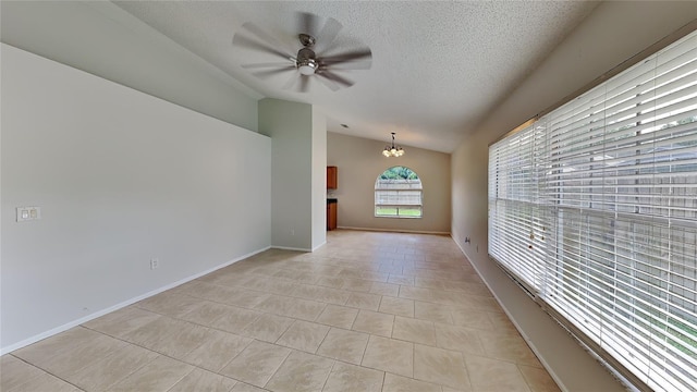 1421 Mohrlake Dr, Brandon, FL 33511 - empty room with lofted ceiling, light tile patterned floors, a chandelier, a ceiling fan, and a textured ceiling