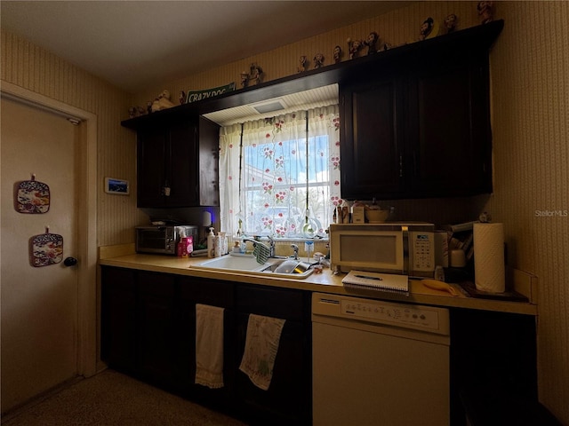 1106 Trellis Ave, Spring Hill, FL 34606 - kitchen featuring white appliances, light countertops, wallpapered walls, and dark cabinetry