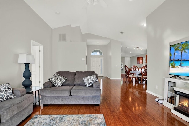 18419 Merseyside Loop, Land O Lakes, FL 34638 - living area featuring wood finished floors, high vaulted ceiling, ceiling fan, healthy amount of natural light, and a glass covered fireplace