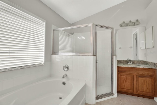 18419 Merseyside Loop, Land O Lakes, FL 34638 - full bath featuring a garden tub, a shower stall, vanity, lofted ceiling, and tile patterned flooring