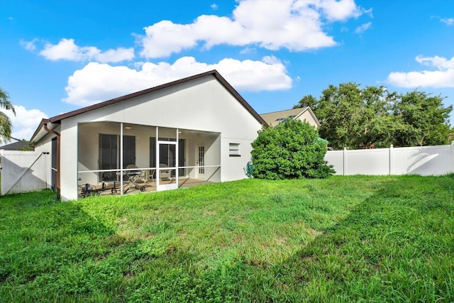 18419 Merseyside Loop, Land O Lakes, FL 34638 - back of house with a fenced backyard, stucco siding, and a sunroom