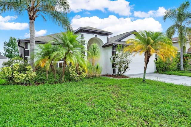 18419 Merseyside Loop, Land O Lakes, FL 34638 - view of front facade with stucco siding, driveway, a garage, and a front lawn