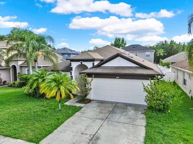 18419 Merseyside Loop, Land O Lakes, FL 34638 - ranch-style house featuring stucco siding, a front lawn, an attached garage, concrete driveway, and roof with shingles