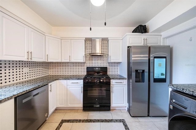 12995 NE 5th Ave, North Miami, FL 33161 - kitchen featuring appliances with stainless steel finishes, wall chimney exhaust hood, washer / clothes dryer, light tile patterned flooring, and white cabinetry