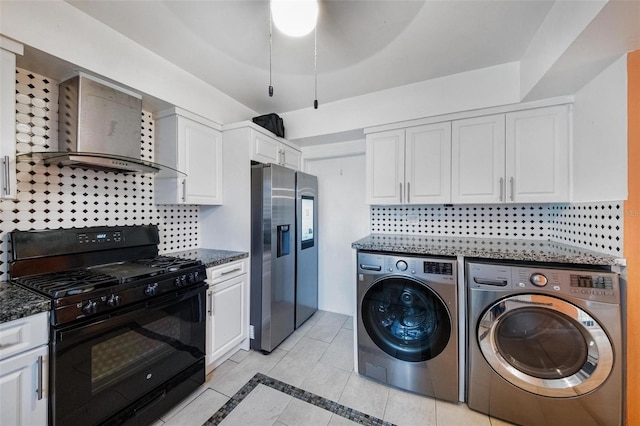 12995 NE 5th Ave, North Miami, FL 33161 - kitchen with black range with gas cooktop, stainless steel fridge with ice dispenser, washing machine and clothes dryer, wall chimney range hood, and white cabinetry