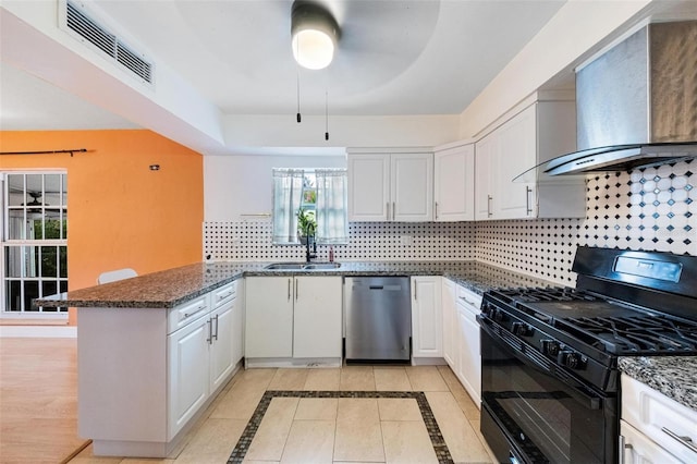 12995 NE 5th Ave, North Miami, FL 33161 - kitchen with black gas stove, dishwasher, wall chimney range hood, a peninsula, and backsplash