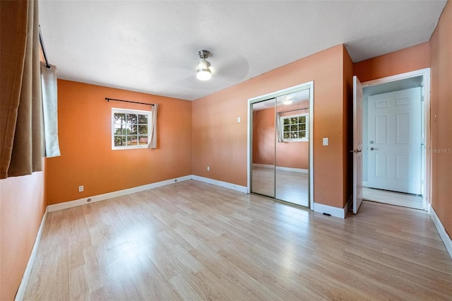12995 NE 5th Ave, North Miami, FL 33161 - unfurnished bedroom featuring light wood-type flooring, a closet, and ceiling fan