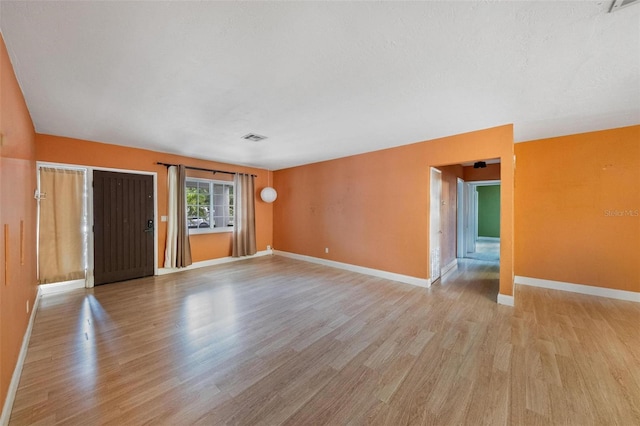 12995 NE 5th Ave, North Miami, FL 33161 - spare room featuring light wood-style flooring and baseboards