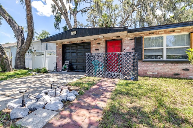 7441 Cypress Dr, New Port Richey, FL 34653 - single story home with brick siding, an attached garage, and driveway