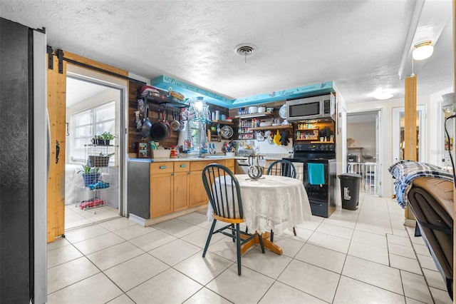 7441 Cypress Dr, New Port Richey, FL 34653 - dining area with a textured ceiling and light tile patterned floors