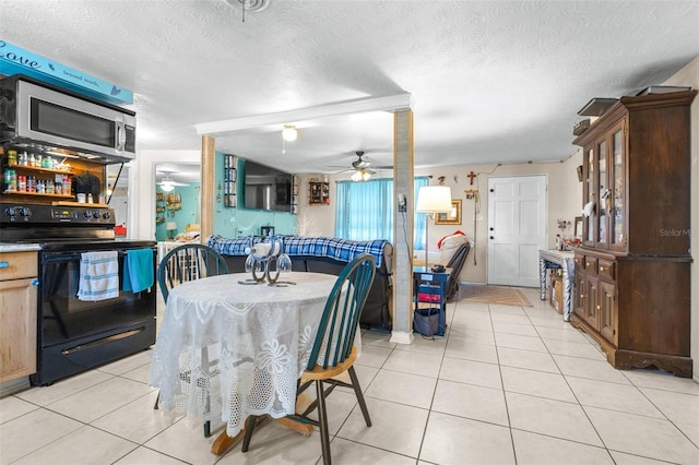 7441 Cypress Dr, New Port Richey, FL 34653 - dining space with ceiling fan, light tile patterned floors, and a textured ceiling