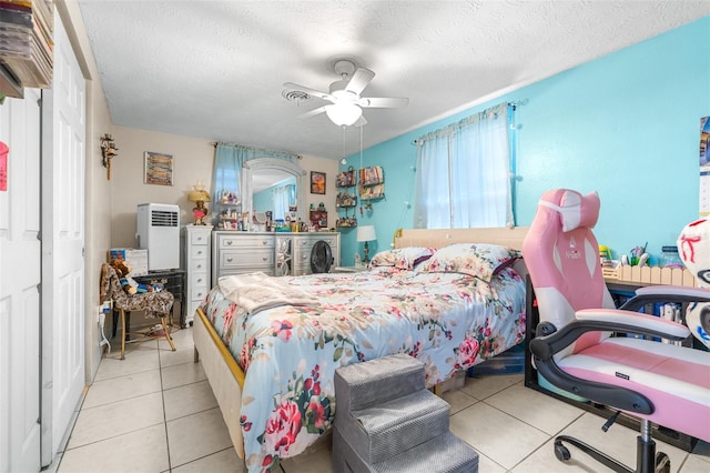 7441 Cypress Dr, New Port Richey, FL 34653 - bedroom with tile patterned flooring, a textured ceiling, and a ceiling fan