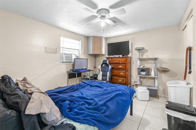 7441 Cypress Dr, New Port Richey, FL 34653 - bedroom featuring a textured ceiling, light tile patterned floors, a ceiling fan, and cooling unit