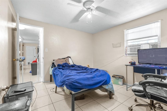 7441 Cypress Dr, New Port Richey, FL 34653 - tiled bedroom featuring a ceiling fan and a textured ceiling