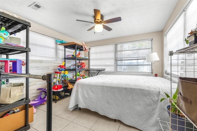 7441 Cypress Dr, New Port Richey, FL 34653 - tiled bedroom featuring a textured ceiling and a ceiling fan