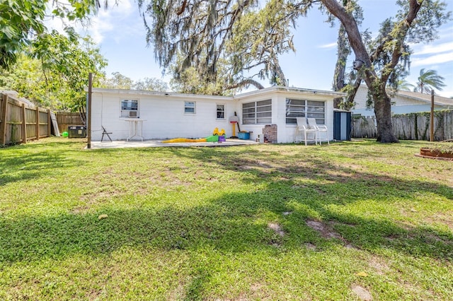 7441 Cypress Dr, New Port Richey, FL 34653 - back of house with a fenced backyard and a patio