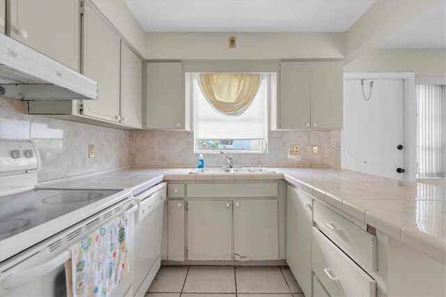 7000 Lafayette N, Pinellas Park, FL 33781 - kitchen featuring white appliances, exhaust hood, tile countertops, and light tile patterned floors