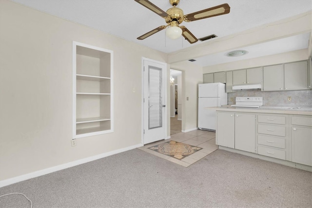 7000 Lafayette N, Pinellas Park, FL 33781 - kitchen with freestanding refrigerator, light carpet, under cabinet range hood, light countertops, and ceiling fan