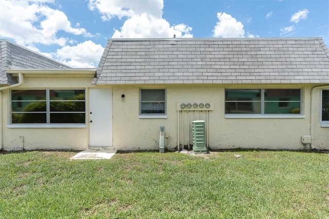 7000 Lafayette N, Pinellas Park, FL 33781 - back of property featuring stucco siding, a lawn, and roof with shingles