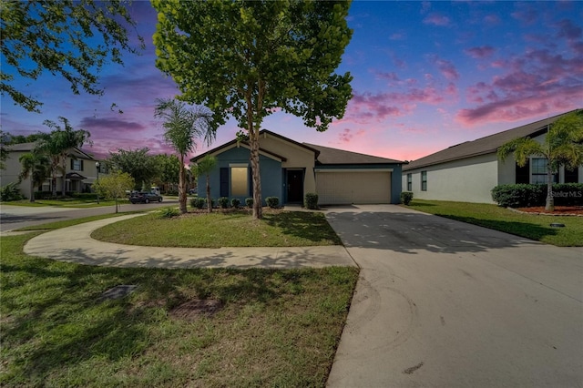 10119 Rose Petal Pl, Riverview, FL 33578 - view of front of property featuring concrete driveway, a yard, an attached garage, and stucco siding