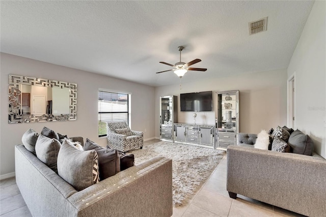 10119 Rose Petal Pl, Riverview, FL 33578 - living area featuring a ceiling fan, light tile patterned floors, and a textured ceiling
