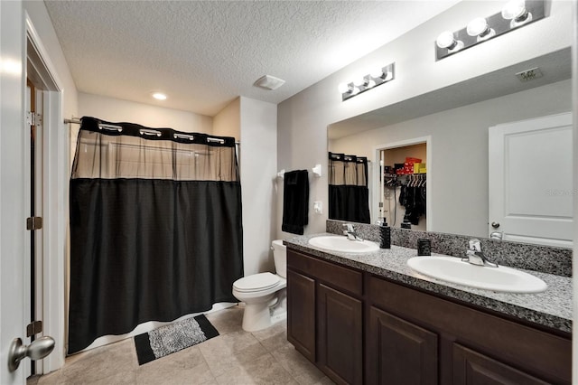 10119 Rose Petal Pl, Riverview, FL 33578 - full bath with double vanity, a textured ceiling, a walk in closet, tile patterned floors, and curtained shower